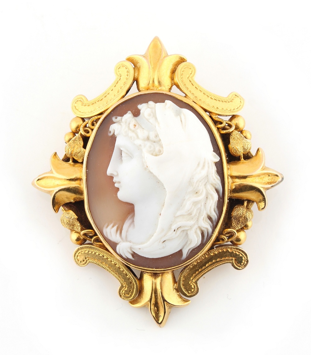 A Victorian unmarked yellow gold shell cameo brooch depicting a classical head wearing a lion head