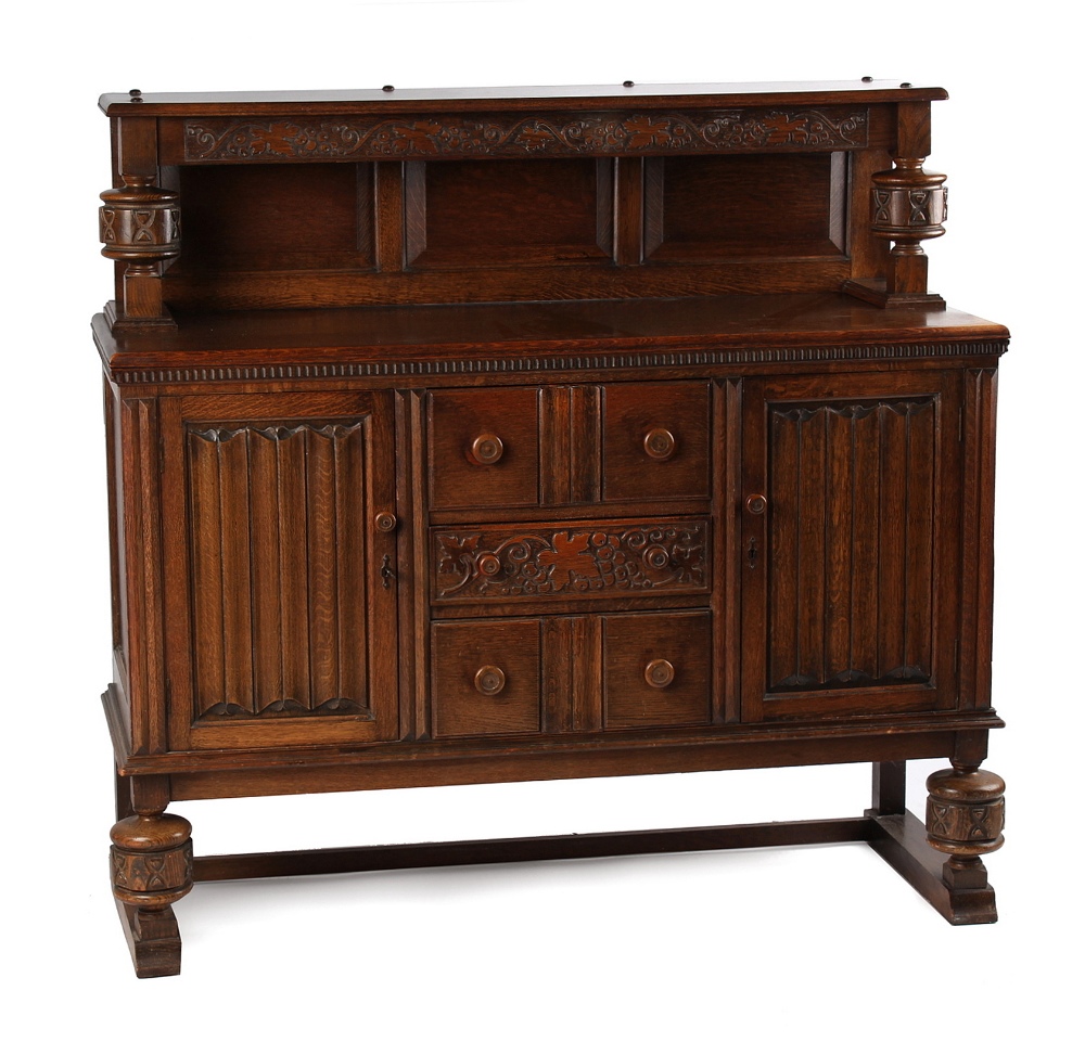 Property of a deceased estate - a reproduction carved oak sideboard with linenfold decorations,