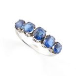 A sapphire five stone ring, the five clear vibrant blue oval cut sapphires weighing a total of