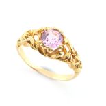 An unmarked high carat yellow gold pink topaz ring, the round cut pink topaz weighing