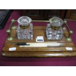 An Early XX Century Double Desk Inkwell, on wooden base, with brass surround and two bottles plus