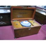 A XIX Century Rosewood Tea Caddy with sarcophagus top, blue and white mixing bowl on bun feet (