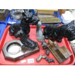 An Art Deco Spelter Terrier, surmounted on angular ash tray, seven other metal dogs, and wooden