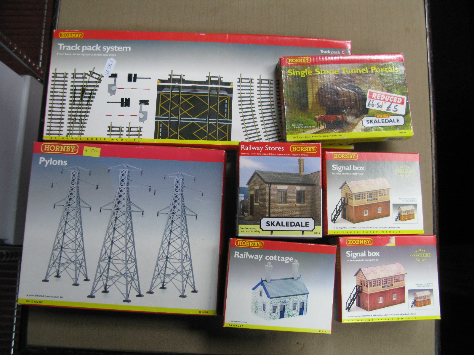 Seven Items of Hornby 'OO' Gauge Trackside Buildings, R8005 signal box (two), cottage, bridge,