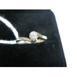 A Modern 9ct Gold Single Stone Diamond Ring, the brilliant cut stone claw set between crossover