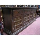 An Oak Sideboard, with three top drawers, over panelled cupboard doors on a plinth base.