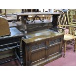 An Oak TV Cabinet, with panelled doors; together with an oak rectangular shaped coffee table. (2)