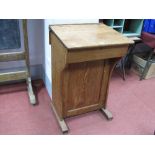 Pitch Pine School Desk, circa 1900, with slope top, twin inkwell apertures, rear cupboard with