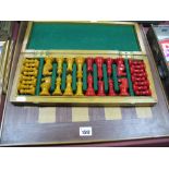 A Carved Resin Chess Set, with amber and red coloured pieces, in fitted case with board.