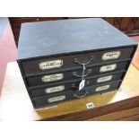 An Early XX Century Four Drawer Morocco Commercial Cabinet, with apothecary labels to each drawer,