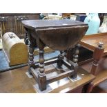 Titmarsh Goodwin style Oak Drop Leaf Coffee Table, with an oval top, on turned and block supports.