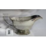 A Hallmarked Silver Sauce Boat, Mappin & Webb, Sheffield 1944, with angular loop handle, on