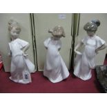 Three Nao Pottery Figurines of Young Ladies, one of which is holding a fan, all boxed. (3)