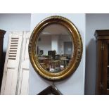 Early XX Century Oval Shaped Gesso Mirror, with foliate decoration, bevelled glass; together with