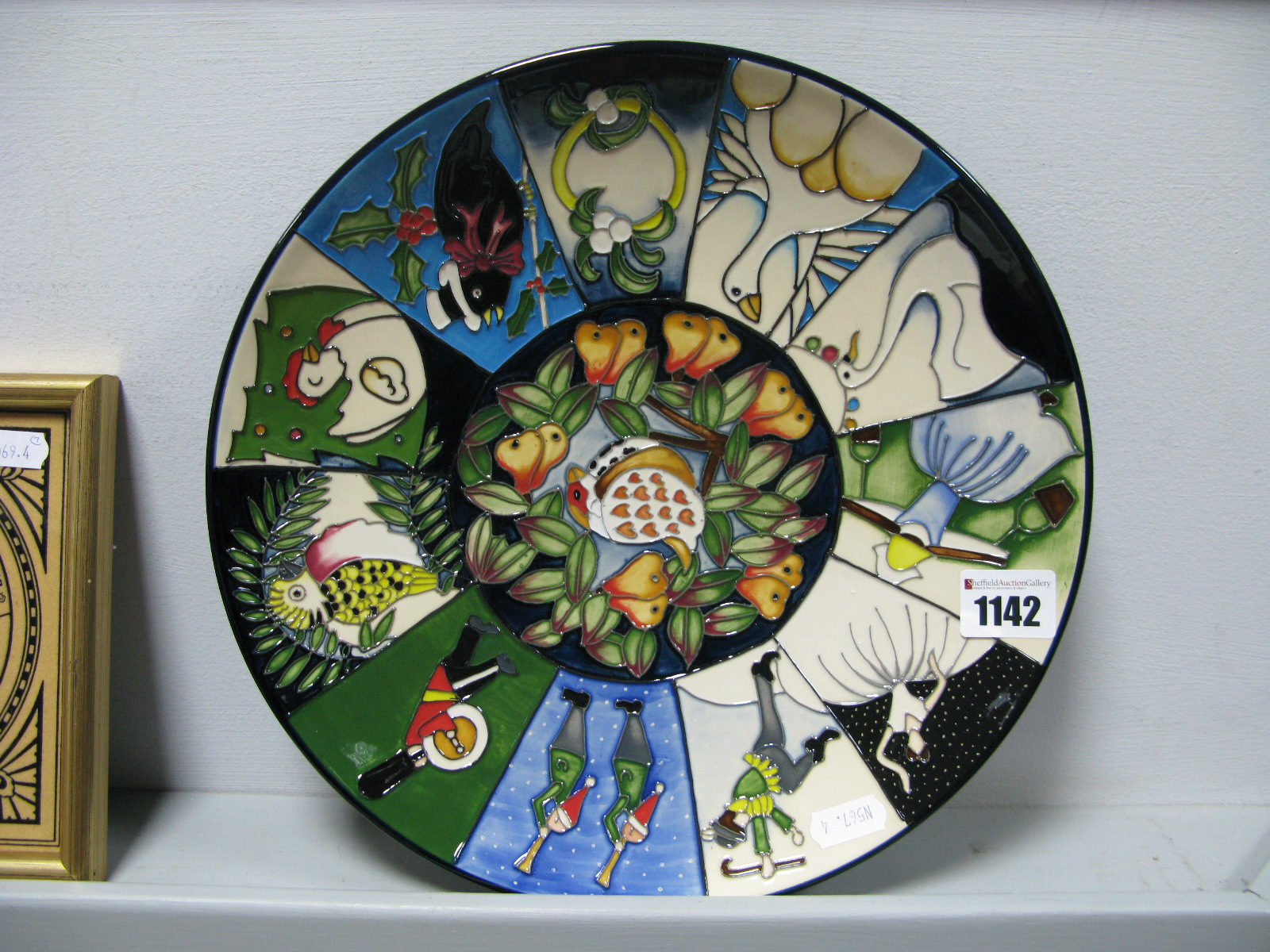 A Moorcroft Pottery Circular Plate, painted with the Twelve Days of Christmas pattern designed by