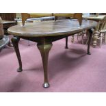 An Early XX Century Mahogany Oval Shaped Dining Table, with a moulded edge, on cabriole legs, pad