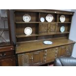 A Mid XX Century Oak Dresser, with rack, twin central doors, open shelves, base with central
