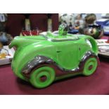 A c.1930's Art Deco Green Pottery Racing Car and Driver Teapot, with registration plate OK T42.