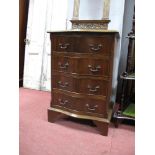 A Mahogany Serpentine Shaped Chest of Drawers, with a crossbanded top, four small drawers on bracket