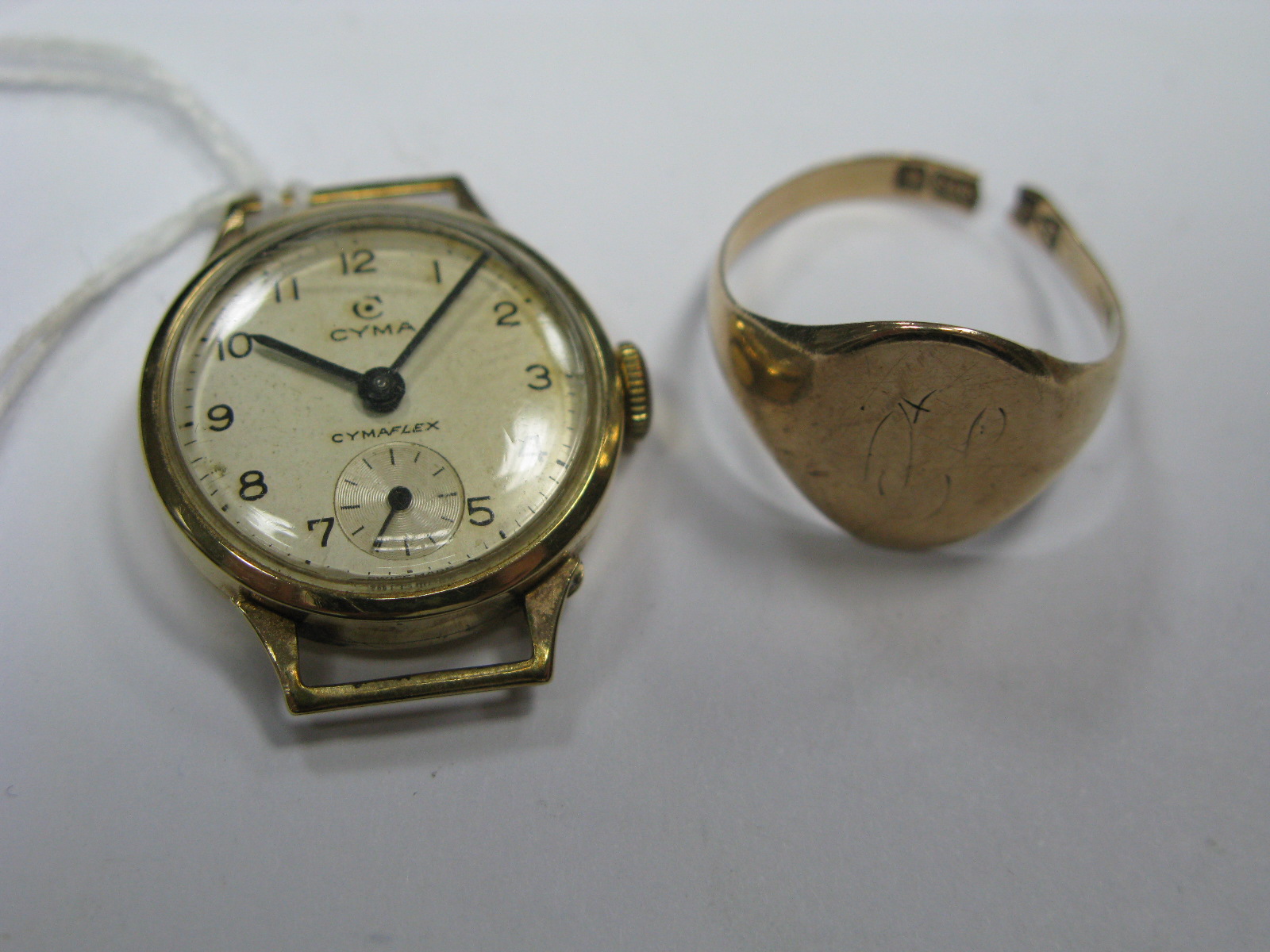 A 9ct Gold Gent's Signet Ring, (shank cut) a 9ct gold cased ladies wristwatch head (lacking strap)