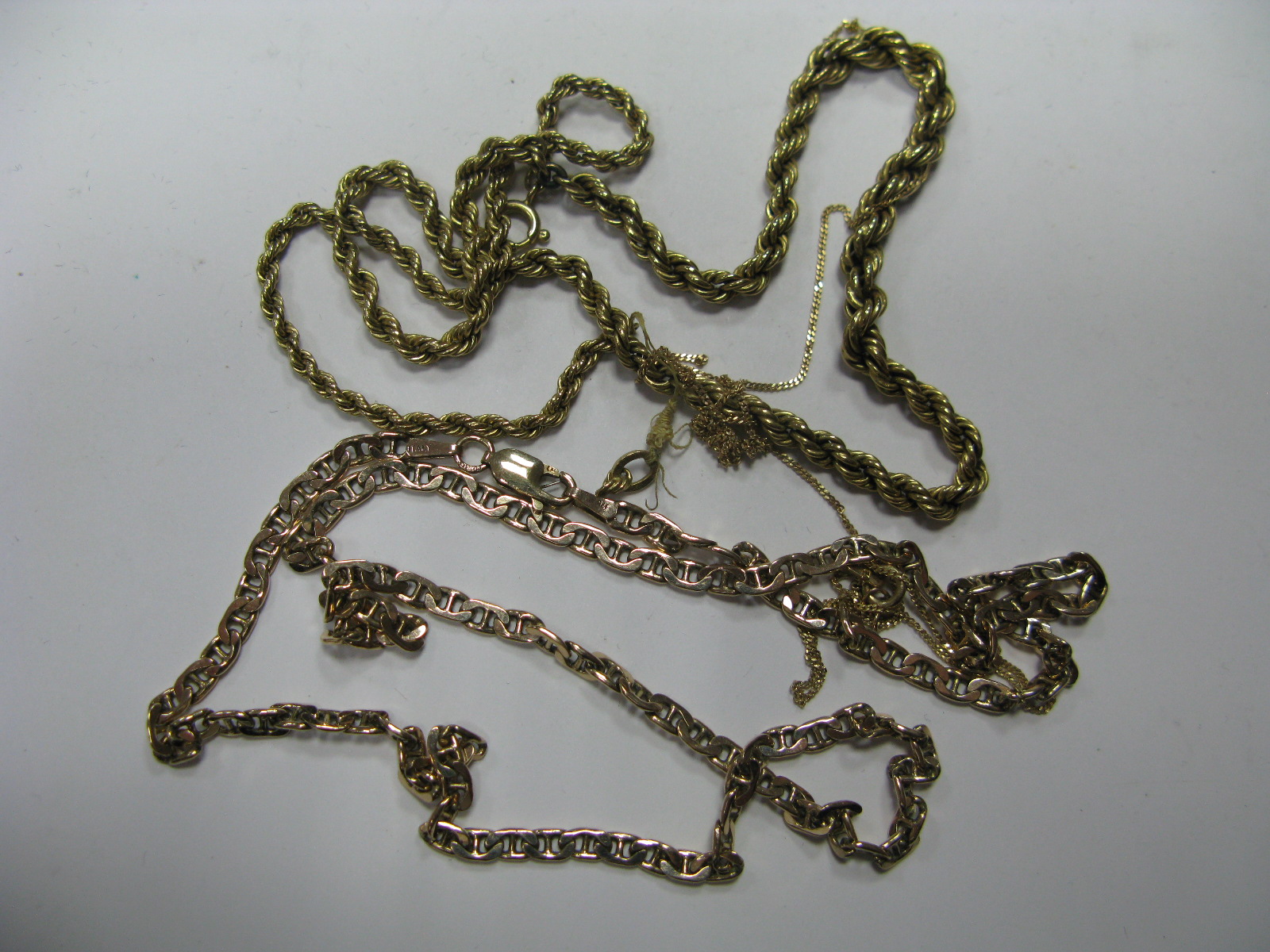 A Modern Fancy Link Chain, stamped "375" (clasp broken); a ropetwist chain (damaged), etc.