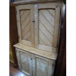 A XIX Century Pine Cupboard, with stepped pediment, slope flanked panelled doors to upper and