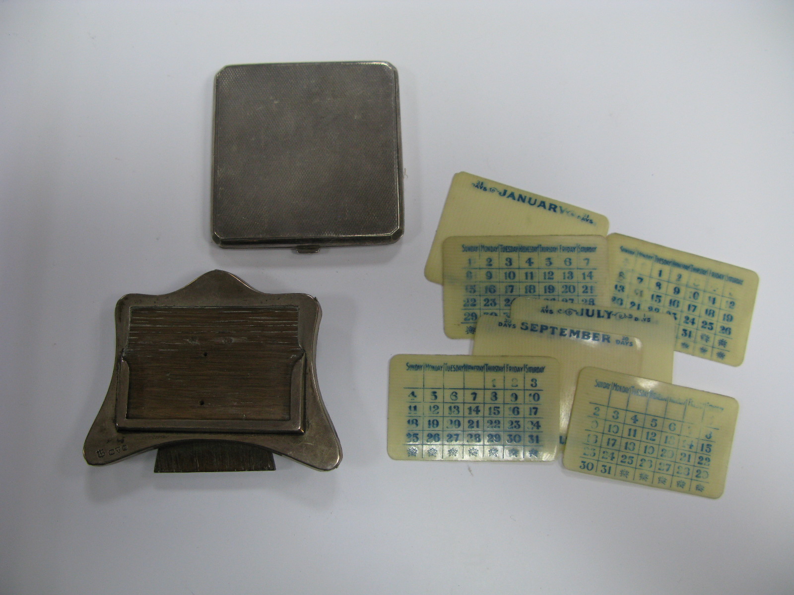 A Hallmarked Silver Mounted Desk Calendar, with date cards; together with a ladies powder compact,