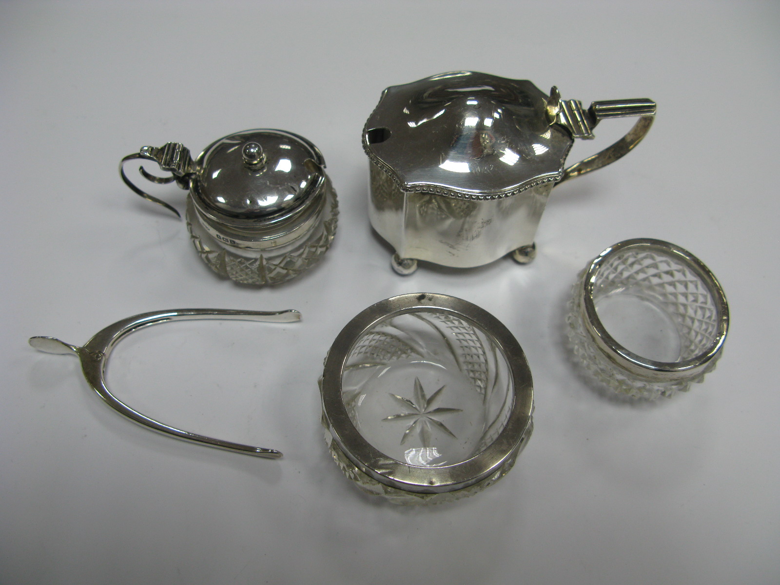 A Hallmarked Silver Mustard, (lacking liner), two hallmarked silver rimmed glass salts, hallmarked