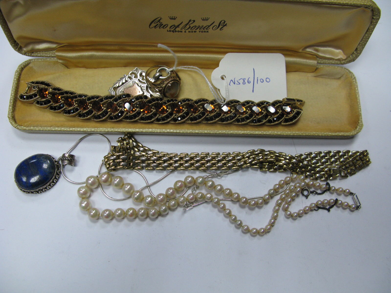 A 9ct Gold Cabochon Set Dress Ring, between bifurcated shoulders, Trifari vintage costume