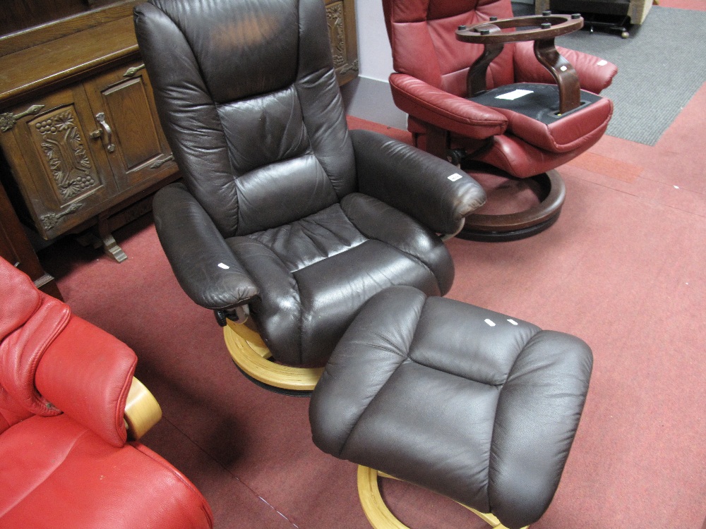 A Brown Leather Stressless Style Chair; together with a footstool. (2)