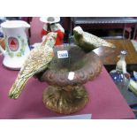 A Cast Iron Bird Bath, with birds on top of a small urn.