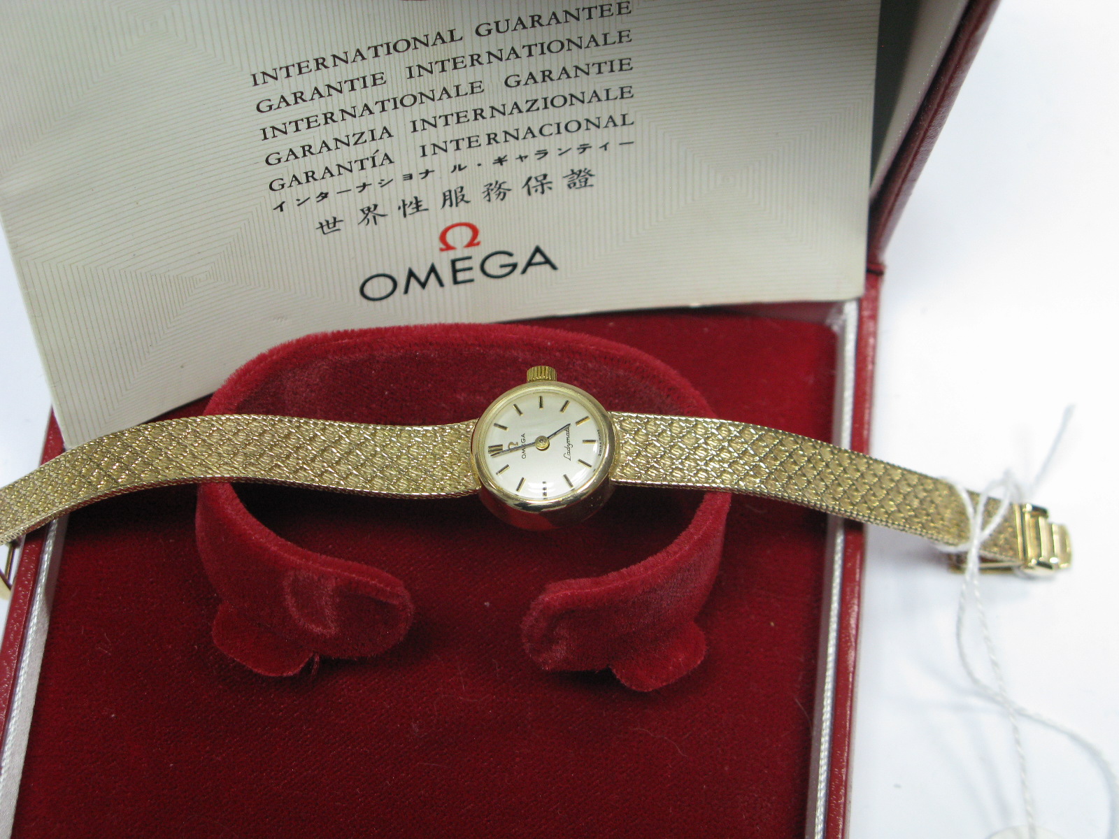 Omega; A 9ct Gold Cased Ladies Wristwatch, to integral textured tapering bracelet, in original box