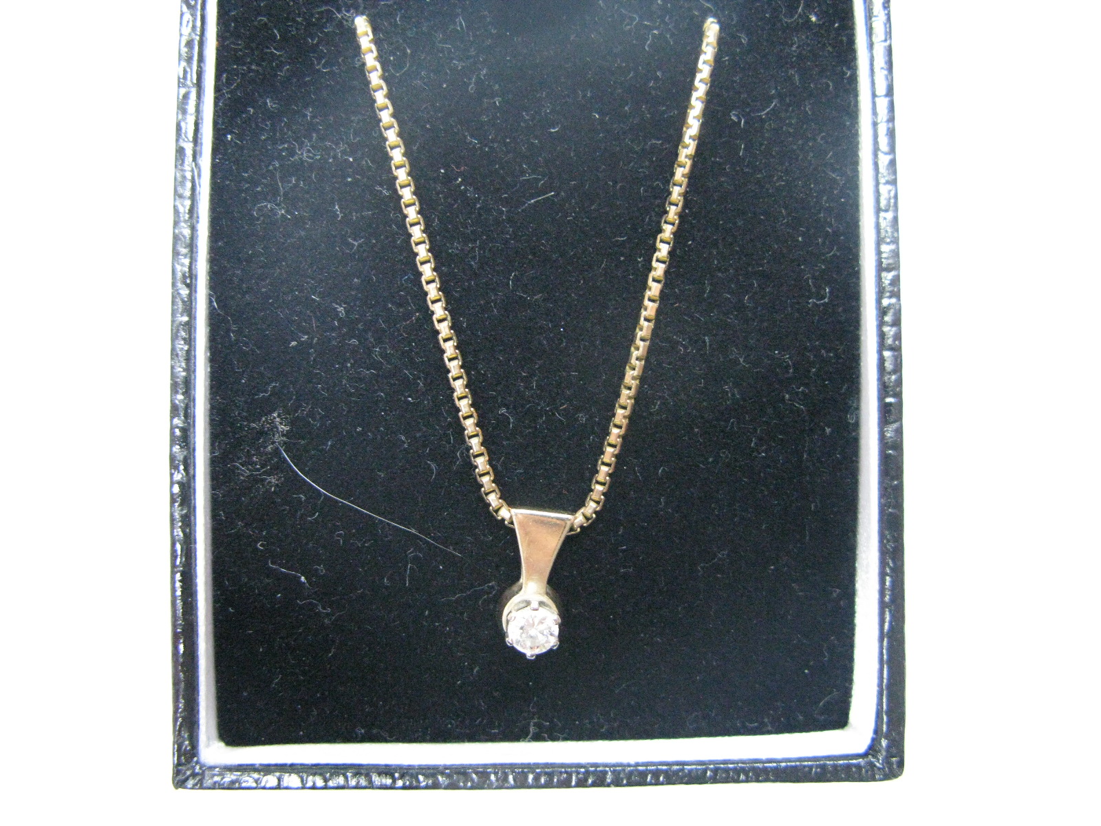 A Modern Single Stone Diamond Pendant, the brilliant cut stone claw set, sliding on a 9ct gold snake