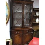 Mahogany Bookcase, with a dentil cornice, twin glazed astragel doors, two small drawers, cupboard