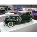 A Danbury Mint 1932 Cadillac V-16 in Green, boxed, appears with both roof options