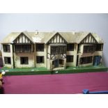 A 1930's No. 64 Large Dolls House, by Lines Brothers/Tri-ang, 140cm long, four opening sections,