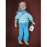 A Bisque Headed German Boy Doll, possibly Heubach, fixed eyes and closed mouth, jointed