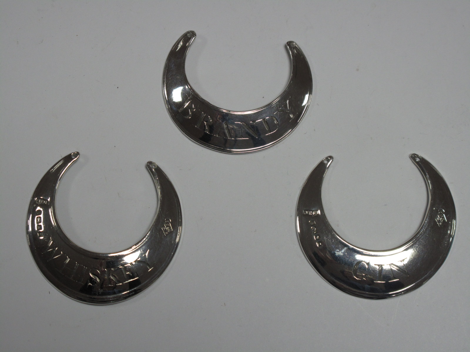 A Pair of Hallmarked Silver Crescent Decanter Labels, JEB, Sheffield 1880, "Whiskey" and "Gin";