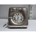 A Hallmarked Silver Mounted Pocketwatch Desk Clock, of planished finish, initialled, fitted with a