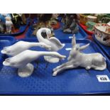 Lladro Pottery Figures, seated donkey and three geese. (4)