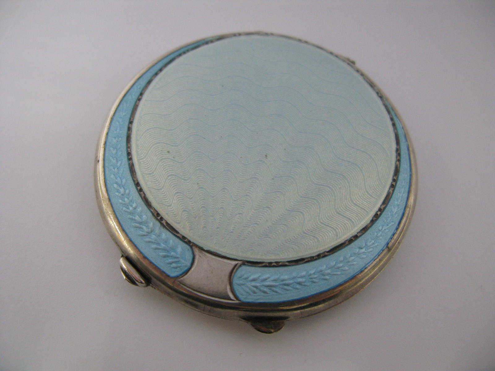 A Hallmarked Silver and Pale Blue Enamel Circular Ladies Compact (lacking puff).