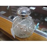 A Hallmarked Silver Topped Cut Glass Globular Scent Bottle, (marks indistinct) the pull off cover