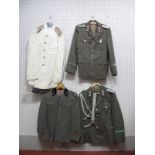 Four Post War Eastern European Military Uniforms, some with badges.