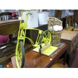 A Yellow Painted Child's Bicycle on Rest, wicker dolls chair.
