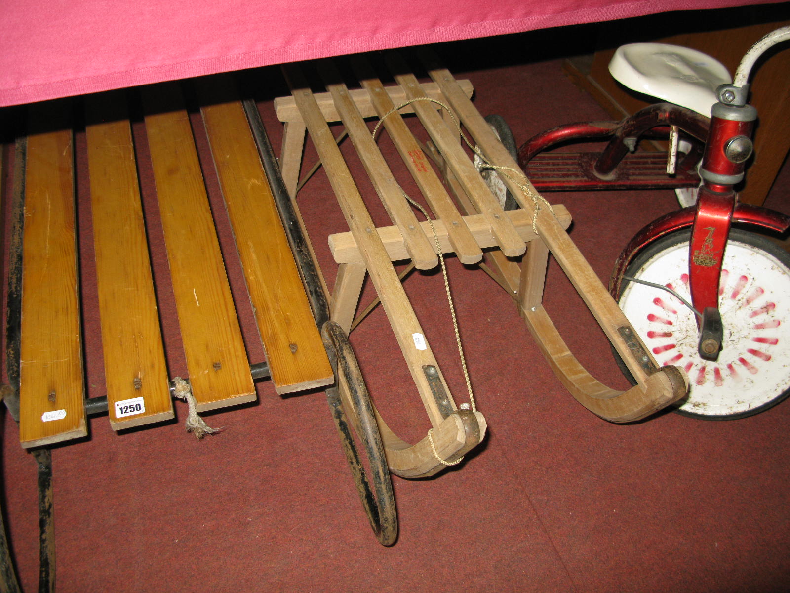 A 1970's Child's Raleigh Tricycle, and two wooden sledges. (3)