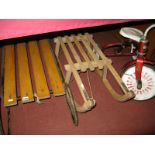 A 1970's Child's Raleigh Tricycle, and two wooden sledges. (3)