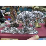 A Silvered Effect Resin Model of a Running Leopard, on naturalistic base, length 57cm.