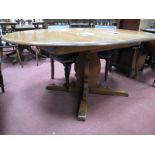 Ercol Extending Draw Leaf Dining Table, with 'D' ends on cruciform base, labelled.