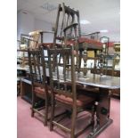 An Ercol Dining Table, together with six (four single and two carvers) rail back chairs.(7)