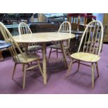 A Set of Four Ercol High Hoop Comb Back Dining Chairs, with rail spindles on splayed legs. An